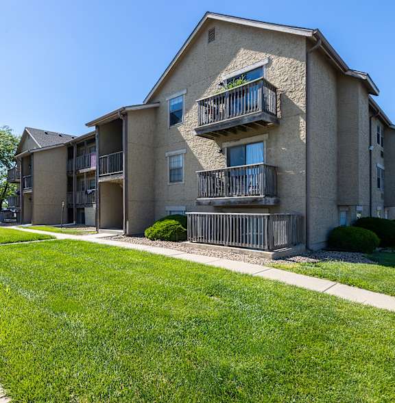 Exterior view of the Southfork Apartments clubhouse with a well-kept lawn.
