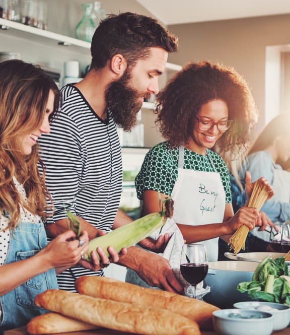 a group of people in a kitchen preparing food