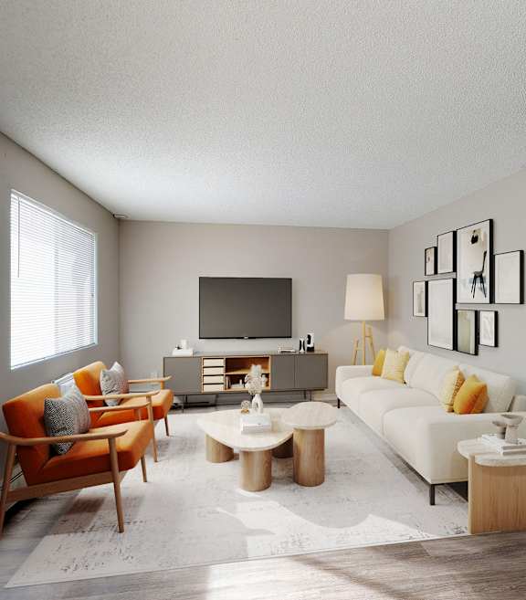 A living room with a white couch, a wooden chair, and a television.