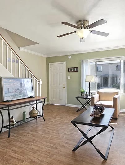 a living room with a couch and a ceiling fan