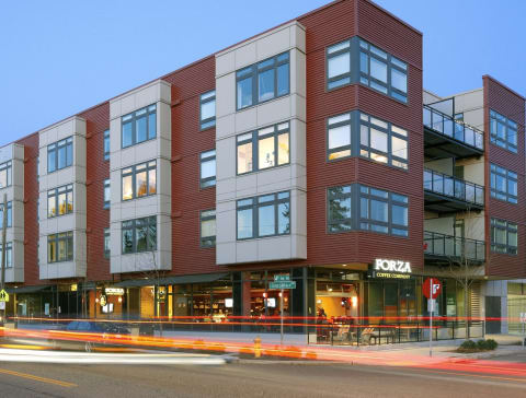 a large building with many windows and a street in front of it