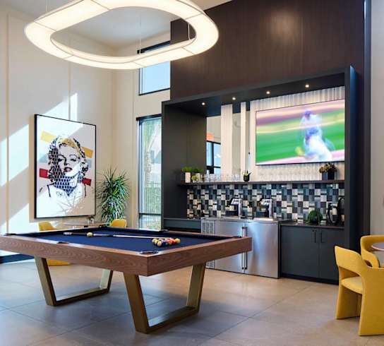 a game room with a pool table and a television