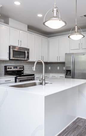 an open kitchen with a granite counter top and stools