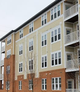 a row of apartment buildings with balconies and trees