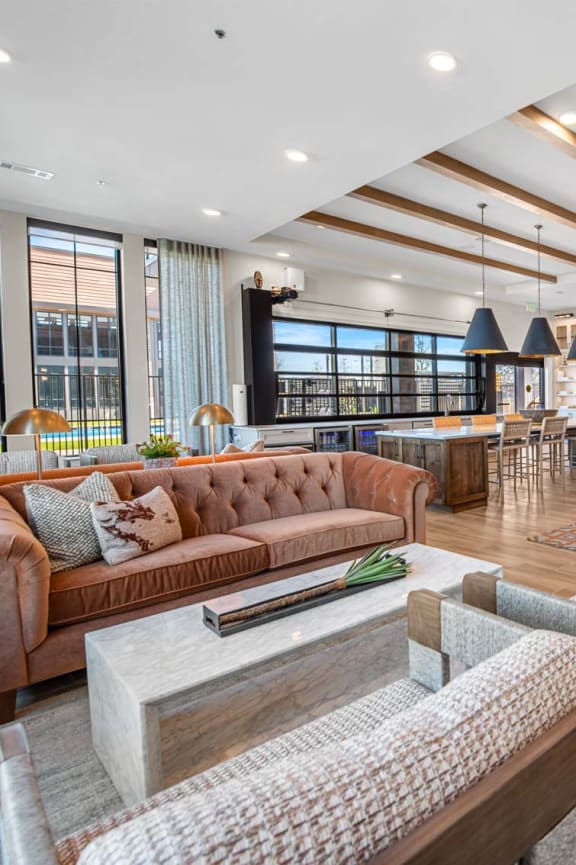 a living room with couches and chairs and a bar