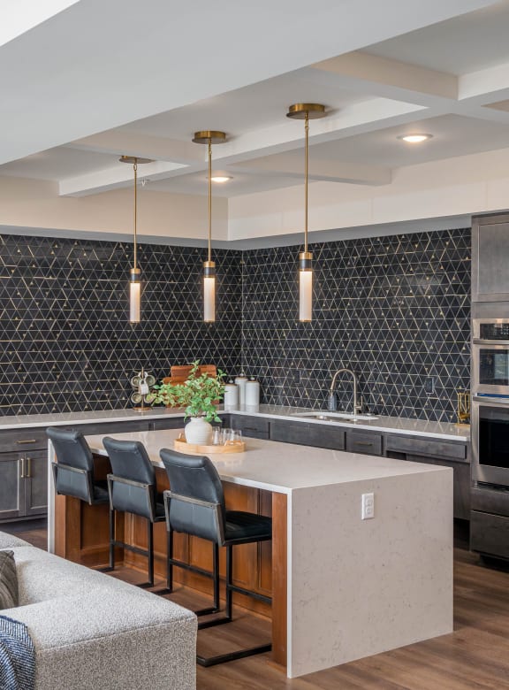 a kitchen and living room with a large island and stainless steel appliances