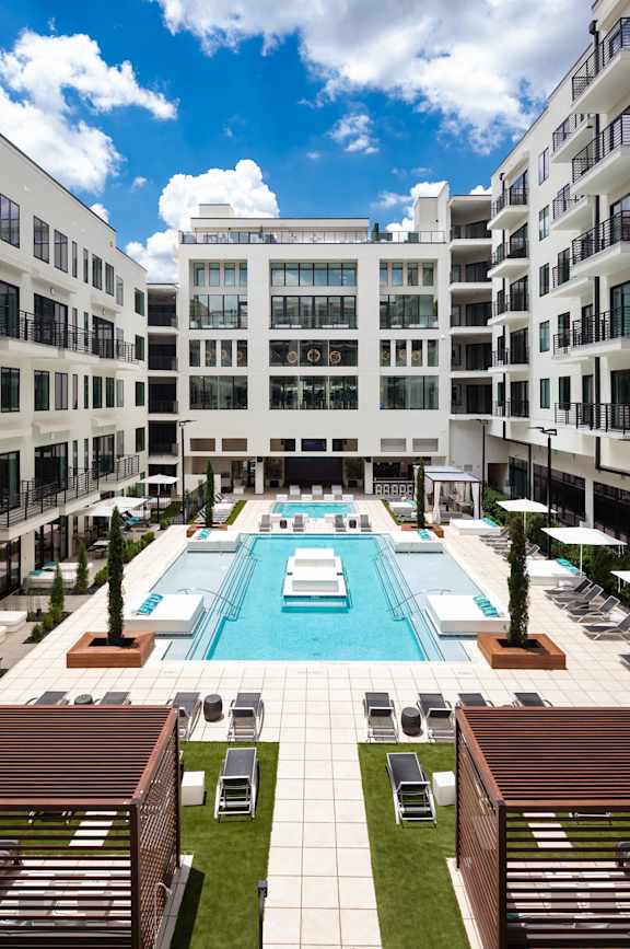a large swimming pool in front of a building
