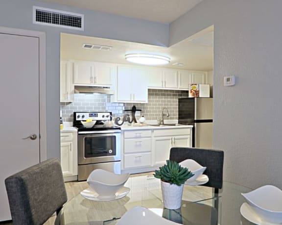 View of Kitchen from the Dining Room with Air Conditioner Vent and Controls on Opposite Walls at Summers Point in Glendale, AZ