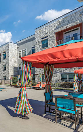 a large pool in front of a brick building