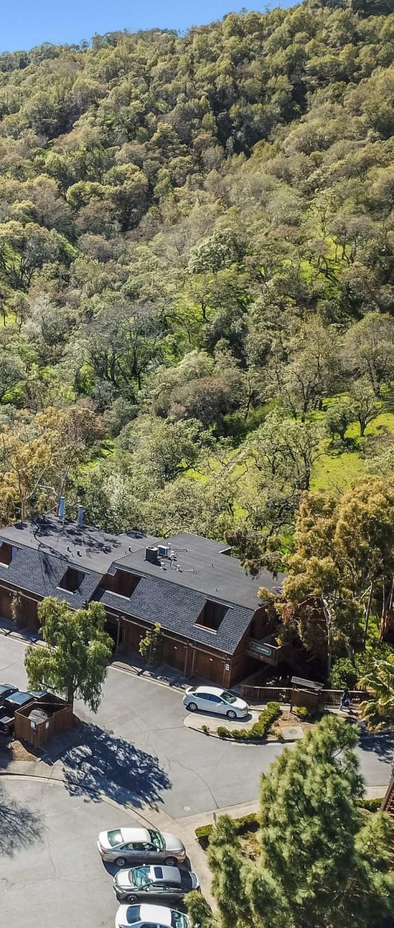 aerial view of apartment buildings and hillside