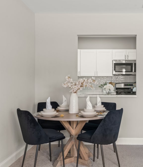 a dining room with a table and chairs and a kitchen at Parkview Towers, New Jersey