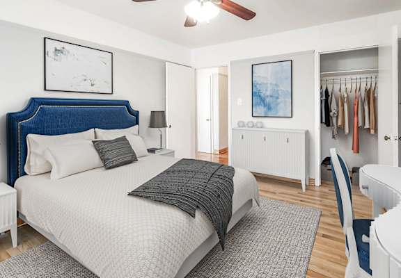 Spacious bedroom at Clarendon Shores in Chicago’s Uptown neighborhood with ceiling fan, natural light, and contemporary decor.