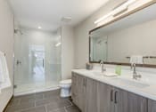 Thumbnail 9 of 27 - Bathroom with a shower and a toilet and a sink at The Brody, Bethesda, Maryland
