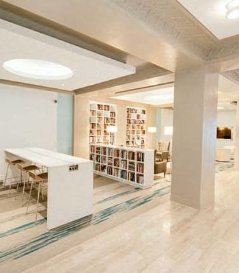 a room with a table and chairs and a bookshelf at 1841 Columbia Road Apartments, Washington, Washington DC