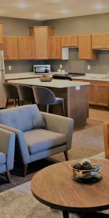 A living room with a couch, chairs, and a coffee table.