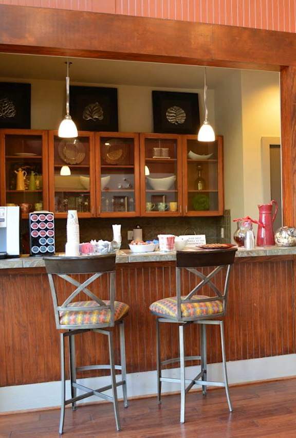 A bar area with two stools and a counter with a few items on it.at Riverview Landing @ Valley Forge, Eagleville Pennsylvania