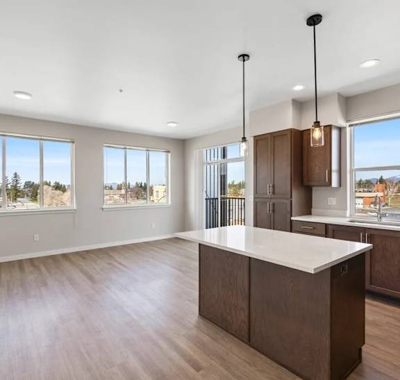 A kitchen with brown cabinets and a white countertop.