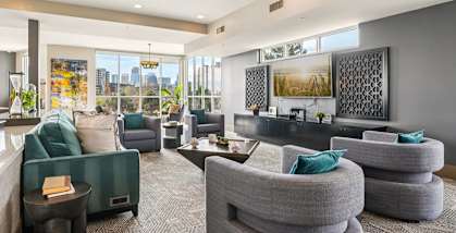 A modern living room with grey and green furniture.