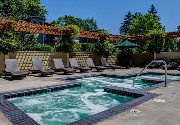 Lounging By Hot Tub, at Commons at Timber Creek Apartments, 12450 NW Barnes Rd, Portland, OR