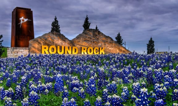 Monument Sign of Round Rock surrounding with bluebonnet