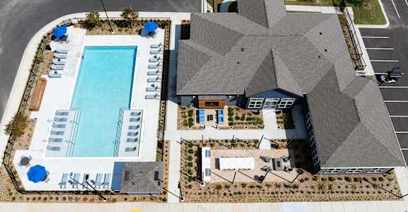 an aerial view of a building with a swimming pool