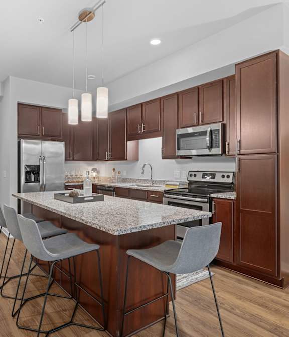 A kitchen with a table and chairs in the middle of it.