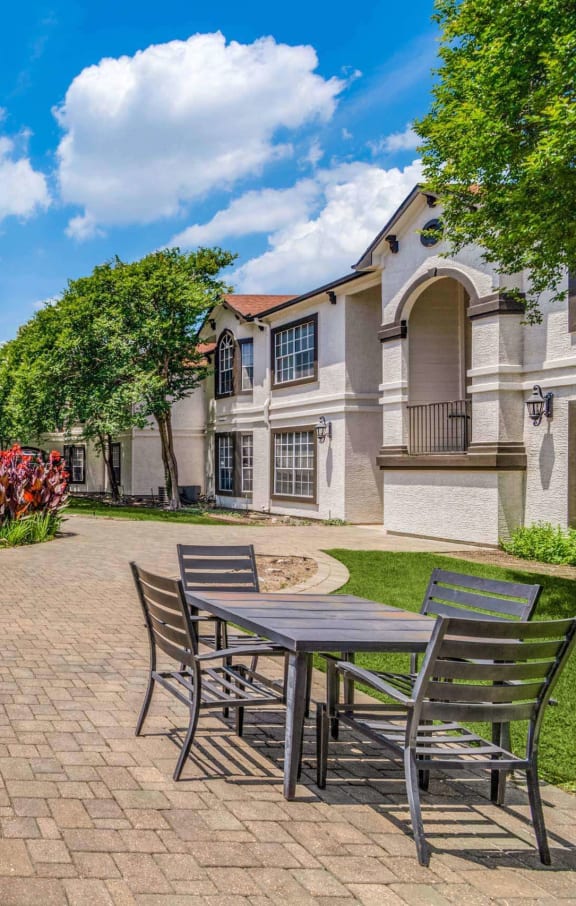 a courtyard with tables and chairs and a fountain