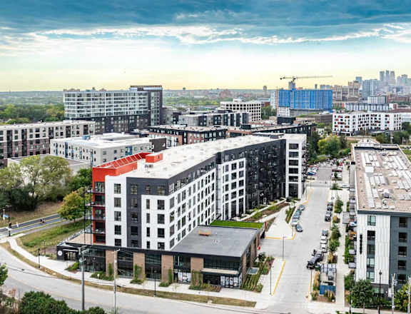 an aerial view of a city with buildings and a parking lot