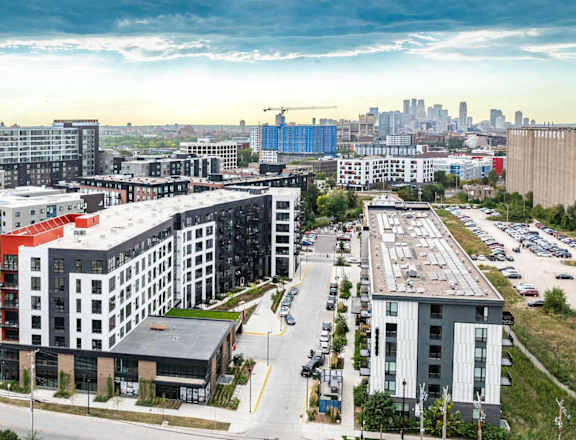 an aerial view of a city with buildings and a parking lot