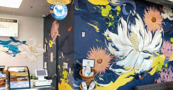 a mural of flowers on a blue and yellow background