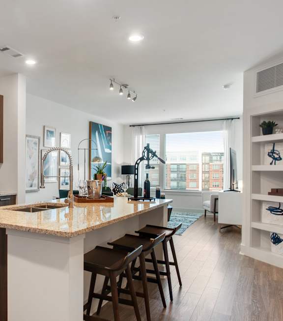A modern kitchen with a large island and wooden cabinets.
