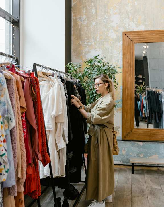 A woman is shopping for clothes in a store.