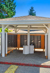 A covered patio area with a table and chairs is surrounded by a red and white striped tape.