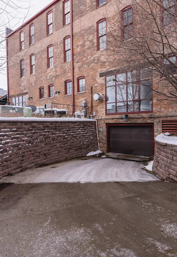 A brick building with a snow-covered ground in front.