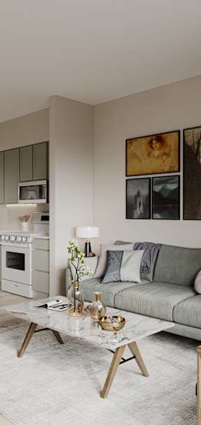 A modern living room with a grey sofa, wooden chairs, and a coffee table.