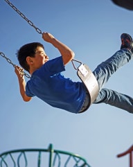 Kid at a playground stock photo at Saguaro Villas Apartments in Tucson AZ