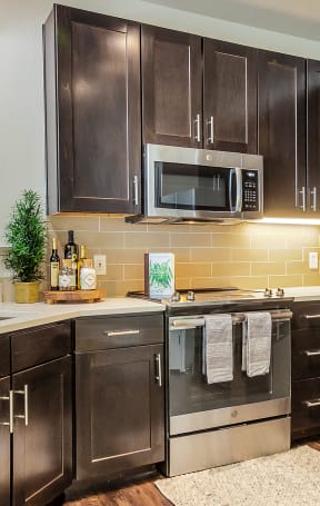 a kitchen with stainless steel appliances and wooden cabinets