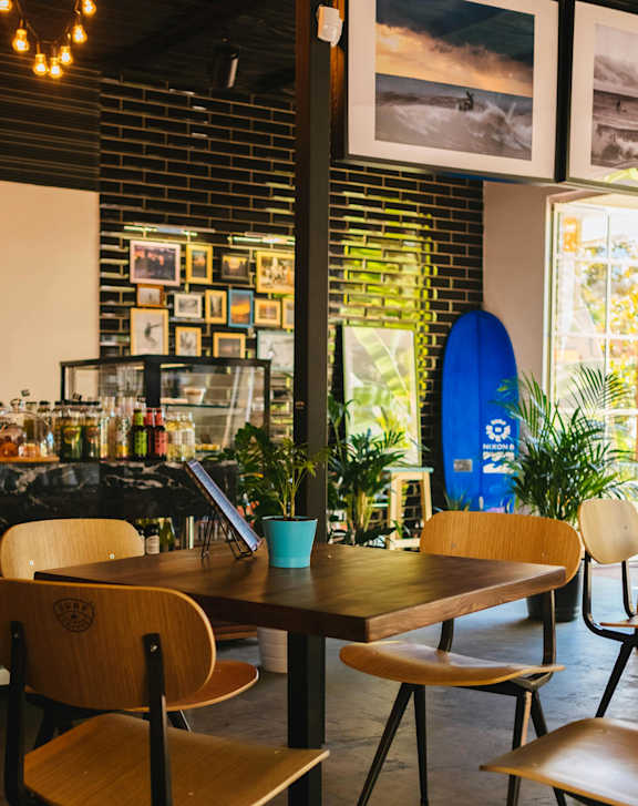 A bar with a counter and chairs.