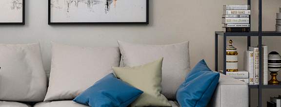 A modern living room with a white sofa, a coffee table, and a TV  at Arbors at Natchez Trace Apartments, Mississippi