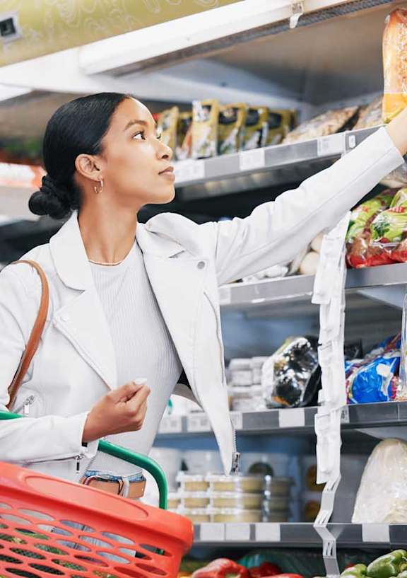 a woman shopping for food in a grocery store
