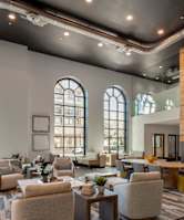 A large room with a staircase and a lot of windows.