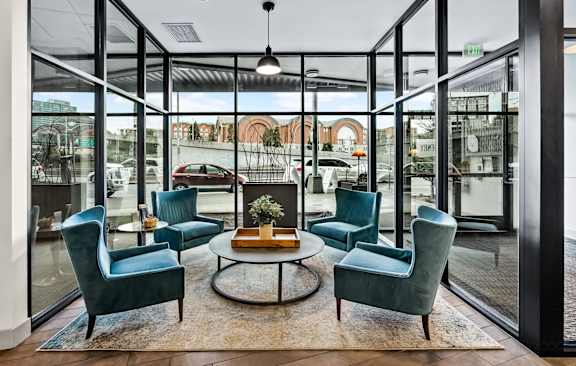 A glass room with a table and chairs in the middle.