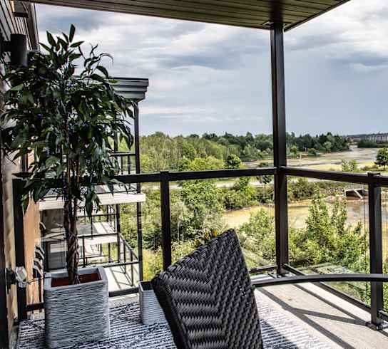 a balcony with a view of a field and trees