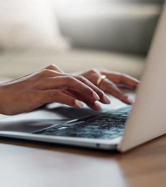 woman working on a laptop computer at a desk