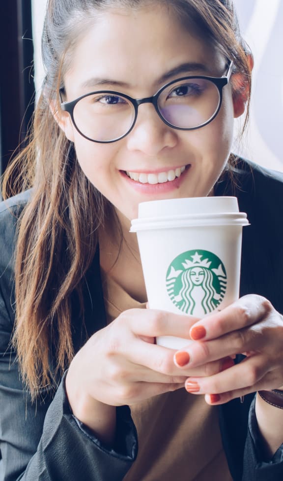 Woman Holding A Coffee at South 16 At The Bridges, Roanoke, 24016