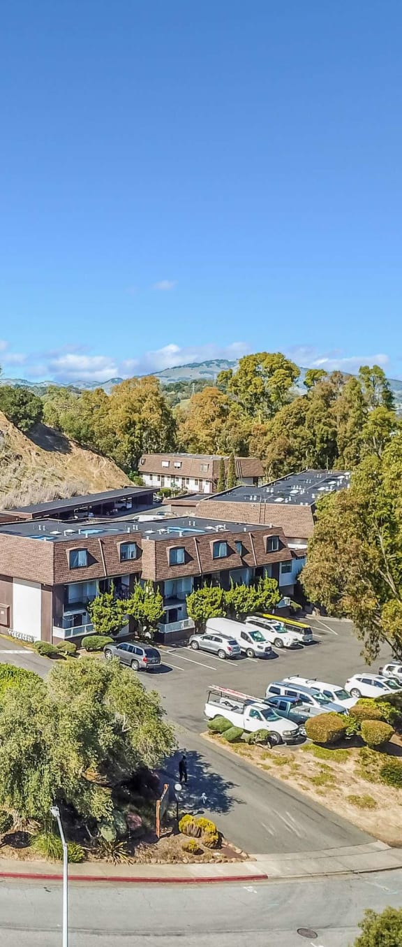 aerial view of apartment buildings and hillside