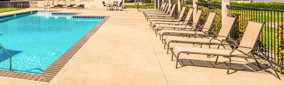 A large swimming pool in front of a building.