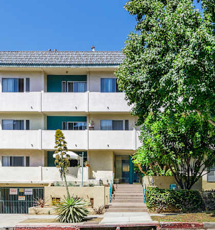 a picture of an apartment building on a sunny day