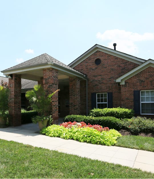 A brick house with a green lawn in front. at The Regency, Manassas, VA