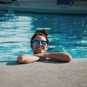 A person is relaxing by the poolside.